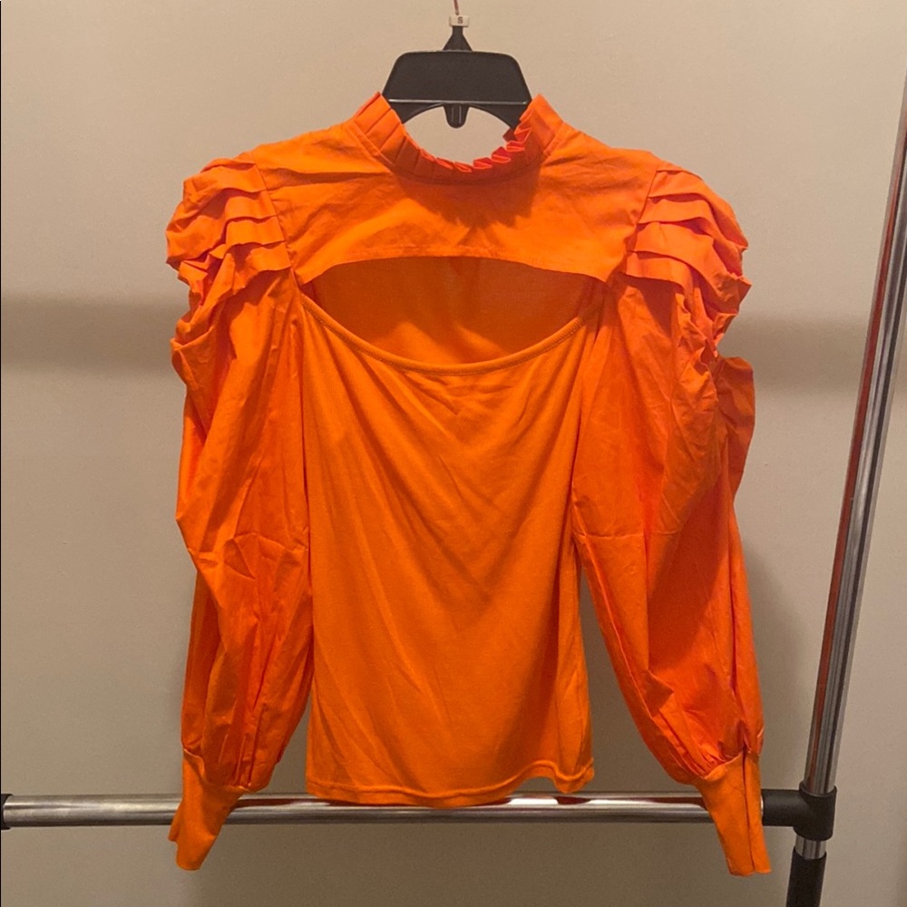 Orange mock neck blouse with puff sleeves and ruffled cut out details